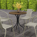 Brown round slatted garden table with black pedestal base in outdoor patio setting.