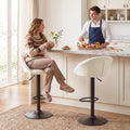 Cream upholstered counter stool with curved back and black round pedestal base