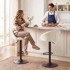 Cream upholstered counter stool with curved back and black round pedestal base