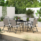 Grey glass-top outdoor dining table with six folding chairs, seven-piece set