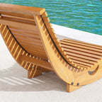 Close-up of wooden rocking chair side with slatted seat and curved metal-free rock frame