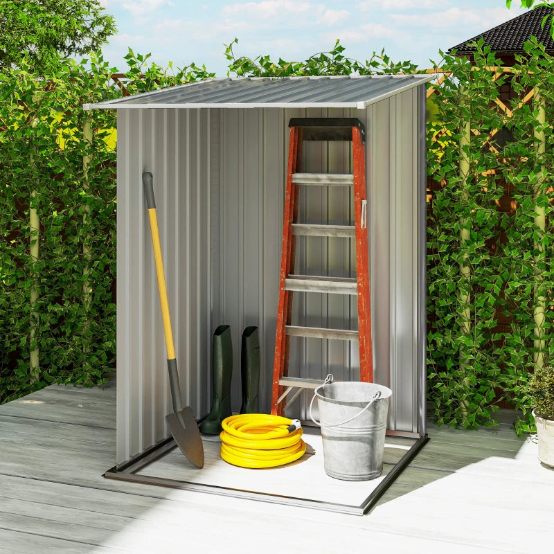 Grey steel garden shed with open door, shelves inside, and yard tools