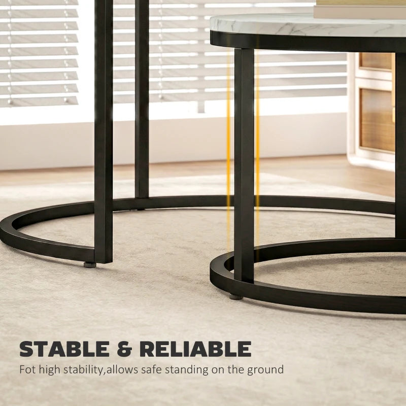 Stable round nesting tables with white marble-effect tops and black circular bases