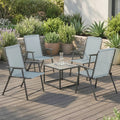 Set of 4 light grey high-back folding chairs with armrests and black frames on outdoor deck