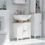 White freestanding bathroom under-sink cabinet with two doors and wood top beside sink