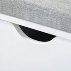 Curved cutout handle under grey cushion on white shoe storage bench