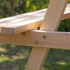 Close-up of natural wood frame and metal screws on a picnic table bench
