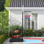 Outdoor basketball hoop stand with backboard and red-blue net by a house walkway