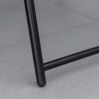 Close-up of black steel leg on folding patio chair frame with rounded corner