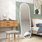 White arched full-length mirror with freestanding stand and rounded frame in a bedroom