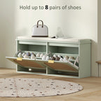 Light green shoe bench with open cubbies holding multiple pairs, flip drawers down