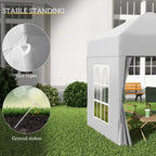 White pop-up gazebo tent with guy ropes and ground stakes for stability