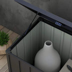 Dark grey galvanized steel storage box interior with large jug on the floor.