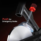 Black exercise bike with red emergency brake knob and silver flywheel cover