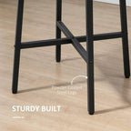 Close-up of black steel legs and cross brace under round rustic brown tabletop
