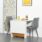 White folding dining table with teak wood base and caster legs, with grey chairs