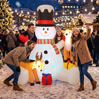 Inflatable snowman with two reindeer, LED lights glowing and striped scarf on display
