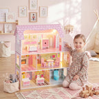 Pink 3-level dollhouse with warm LED lighting, front railing, and furnished interior rooms.
