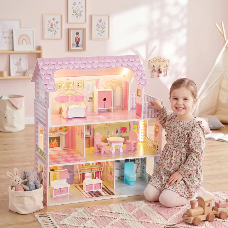 Pink 3-level dollhouse with warm LED lighting, front railing, and furnished interior rooms.