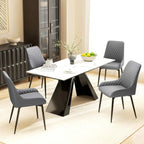 Grey quilted dining chair set around a table with black metal legs