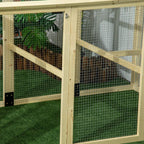 Close-up of wooden chicken run frame with wire mesh panels and interior crossbar