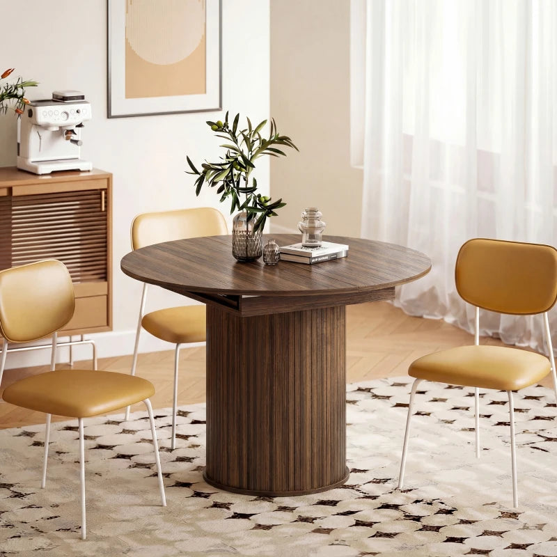 Dark walnut round dining table with pedestal base, set with chairs around it