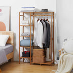 Natural wood bamboo clothes rack with hanging rod, open shelves, and hanging garments