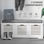 White shoe storage bench with gray cushion and three slatted drawer compartments