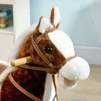 Close-up of plush brown rocking horse head with bridle and white mane