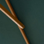 Green parasol canopy with close-up wooden rib and metal joint