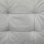 Light grey upholstered sofa seat cushion with stitched padded panels, close-up