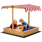 Wooden kids sandbox with striped cover canopy, two children playing in sand with blue basins