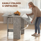 Grey drop-leaf dining table with one side leaf open for serving