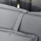 Close-up of dark grey cushion seams and piping on padded high-back chair cushion