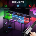 Black LED desk with RGB lighting system, adjustable brightness, and control switch