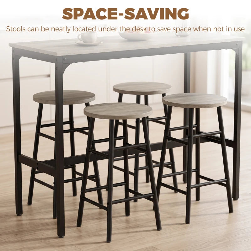 Grey bar table set with four stools tucked under the table, black metal frames
