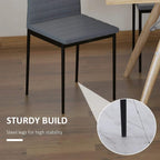 Grey dining chair with steel legs for stability, close-up of leg base