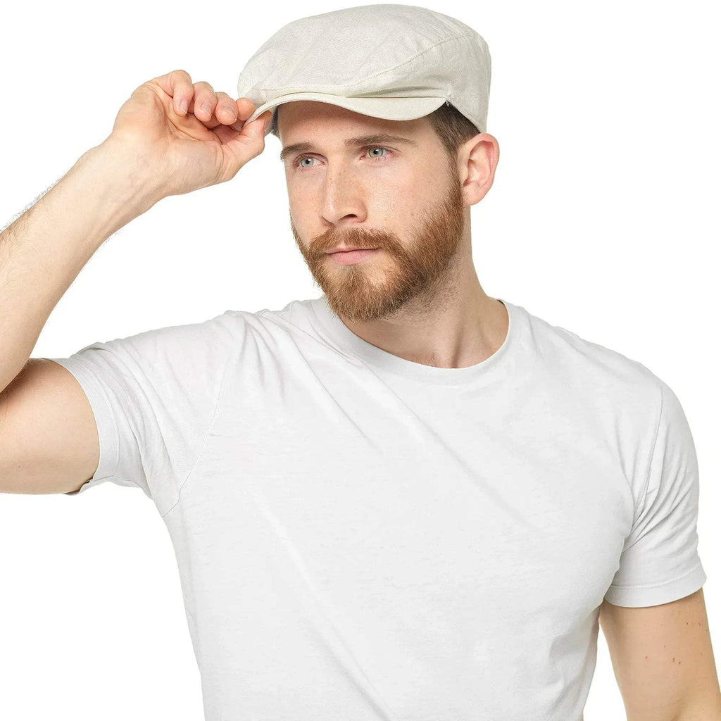 Stone beige linen cap with curved brim and textured fabric, worn by a model