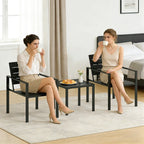 Black bistro table with two matching chairs, slatted backs, for indoor seating