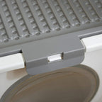 Close-up of gray front flap on white enclosed cat litter box