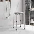 White shower stool with round seat and perforated height-adjustment posts