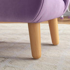 Purple armchair with velvet upholstery and light wood legs