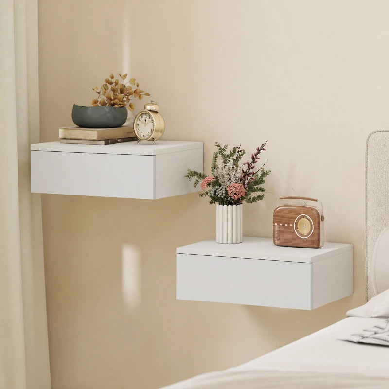 Two white wall-mounted floating nightstands with drawers and flat tops