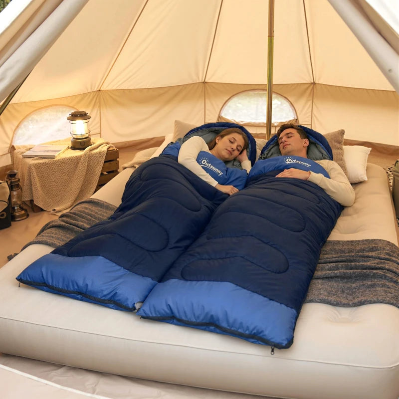 Navy blue sleeping bag set on air mattress inside a tent, two people resting