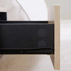Close-up of drawer rail and dark interior inside a floating bedside cabinet