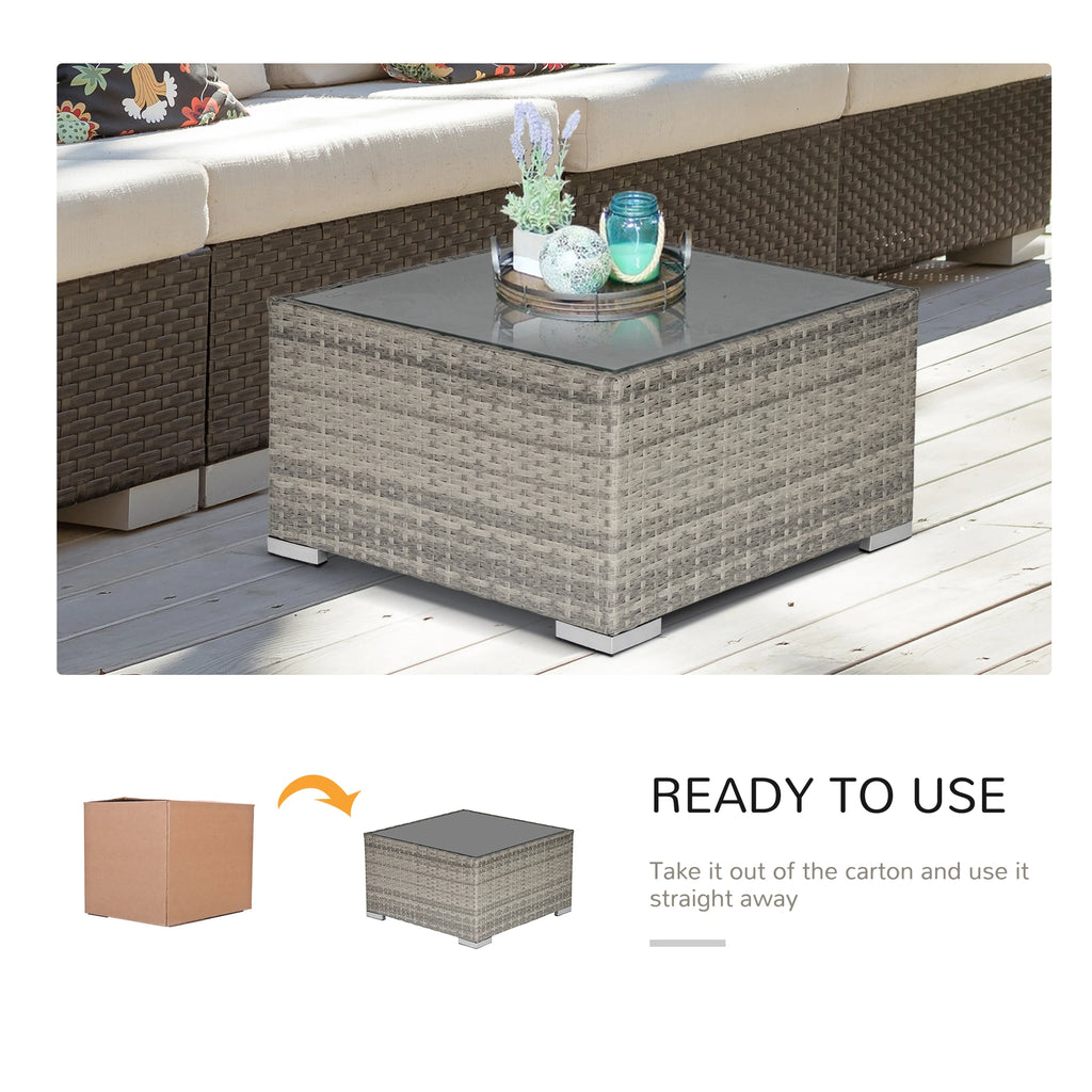 Gray wicker coffee table with glass top shown with patio furniture