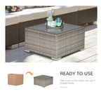 Gray wicker coffee table with glass top shown with patio furniture