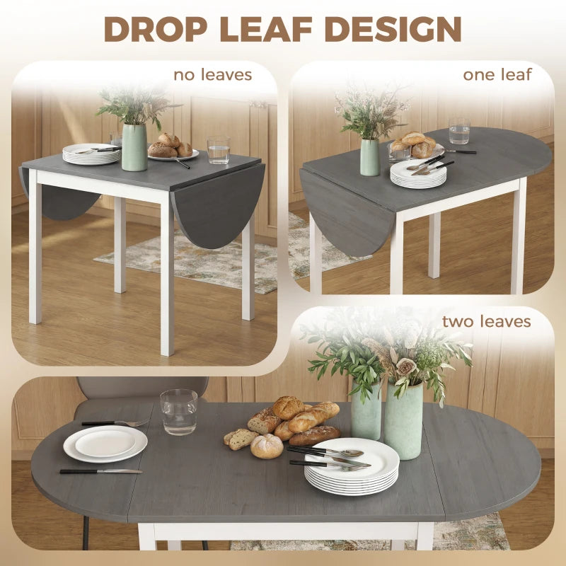 Grey drop-leaf dining table with rounded top, white legs, two leaves open