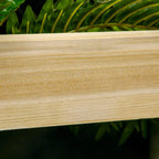 Close-up of natural wood raised planter board with visible grain and smooth finish