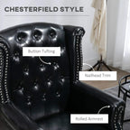 Black Chesterfield-style wingback chair with button tufting and nailhead-trimmed rolled arms